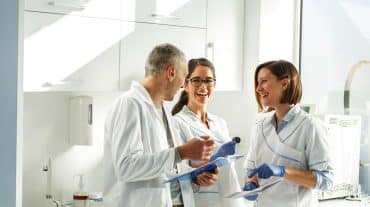 A team of orthodontist work together. How long does it take to transition an orthodontic practice? Learn more about practice transition guidelines in our complete guide.