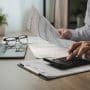 A person reviewing business finances. Rising student debt is changing who can buy an orthodontic practice. What the shift means whether you're buying, selling, or hiring.