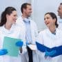 A team of orthodontists work together. Do employees keep their jobs after an orthodontic practice sale? What to negotiate for your team and how to share the news well.