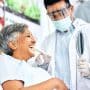 A woman looks at her teeth in the mirror during an ortho visit. Adult orthodontics is growing as pediatric starts slow. Here’s what the shift means for practice strategy, financing, and long-term growth.